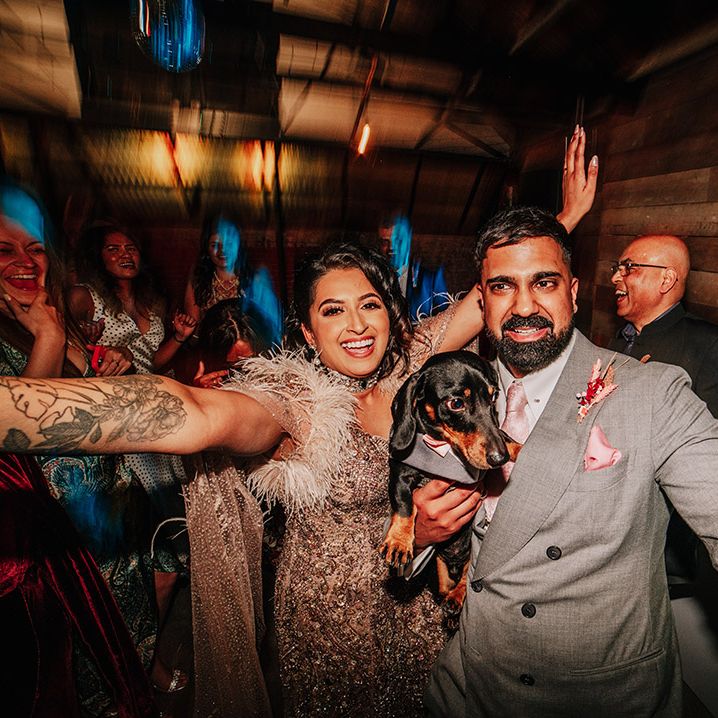 bride-and-groom-with-pet-dog-at-wedding