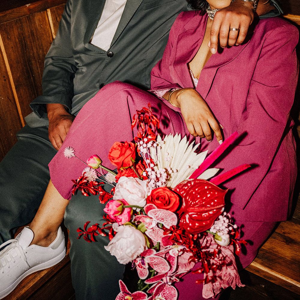 bride-in-pink-suit-and-groom-in-matching-grey-suit-for-reception