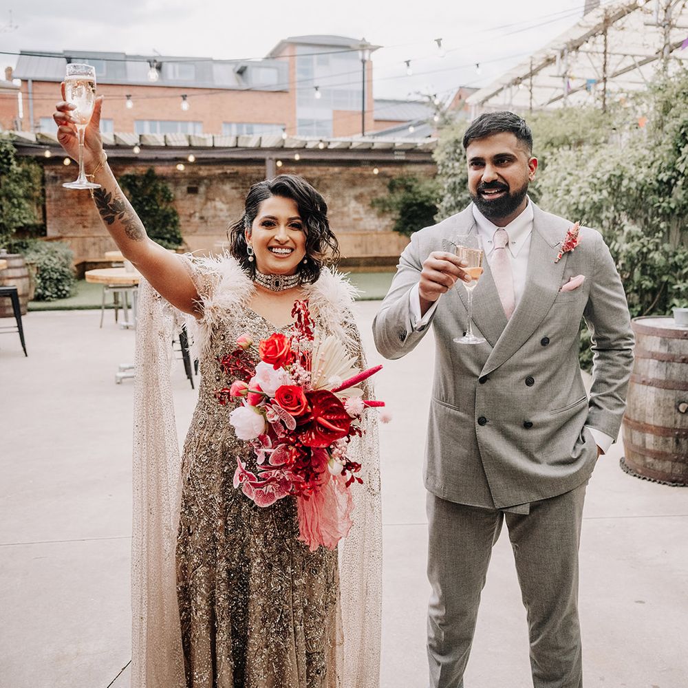 groom-in-light-grey-double-breasted-wedding-suit-with-bride-in-beaded-wedding-dress