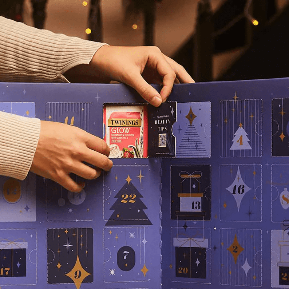 Twinings Tea Advent Calendar 2025 lifestyle image of someone opening a door to 'glow' tea