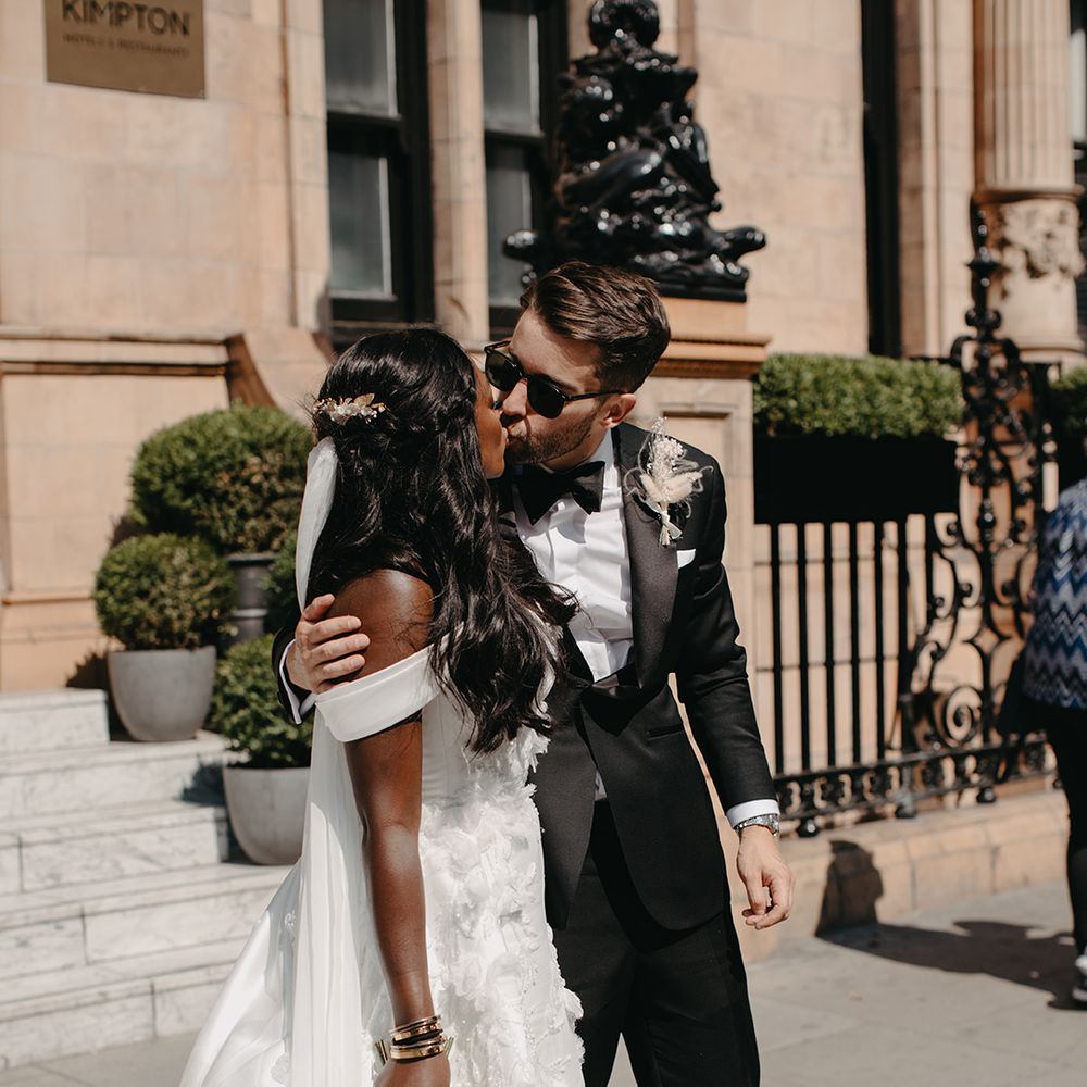bride-in-off-the-shoulder-wedding-dress-kissing-groom
