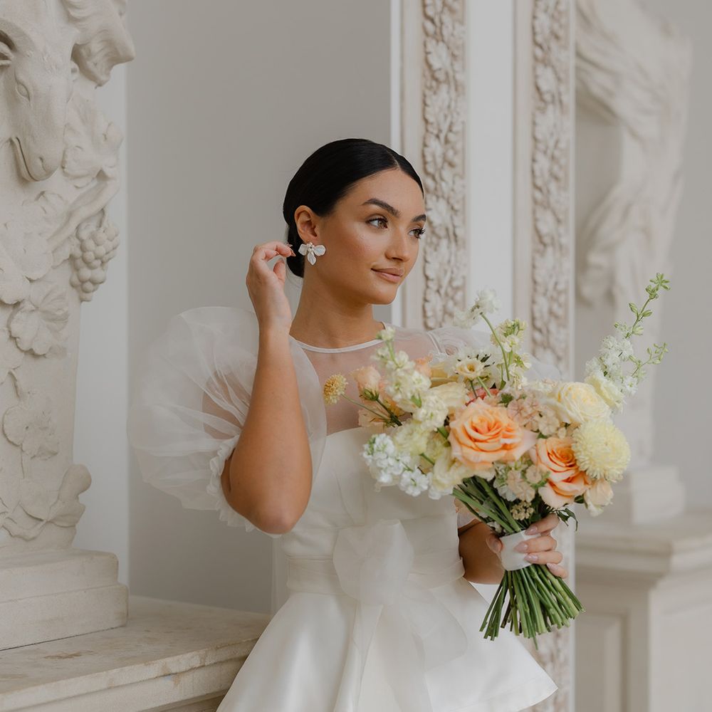 bride-in-peplum-wedding-dress-with-yellow-bridal-bouquet