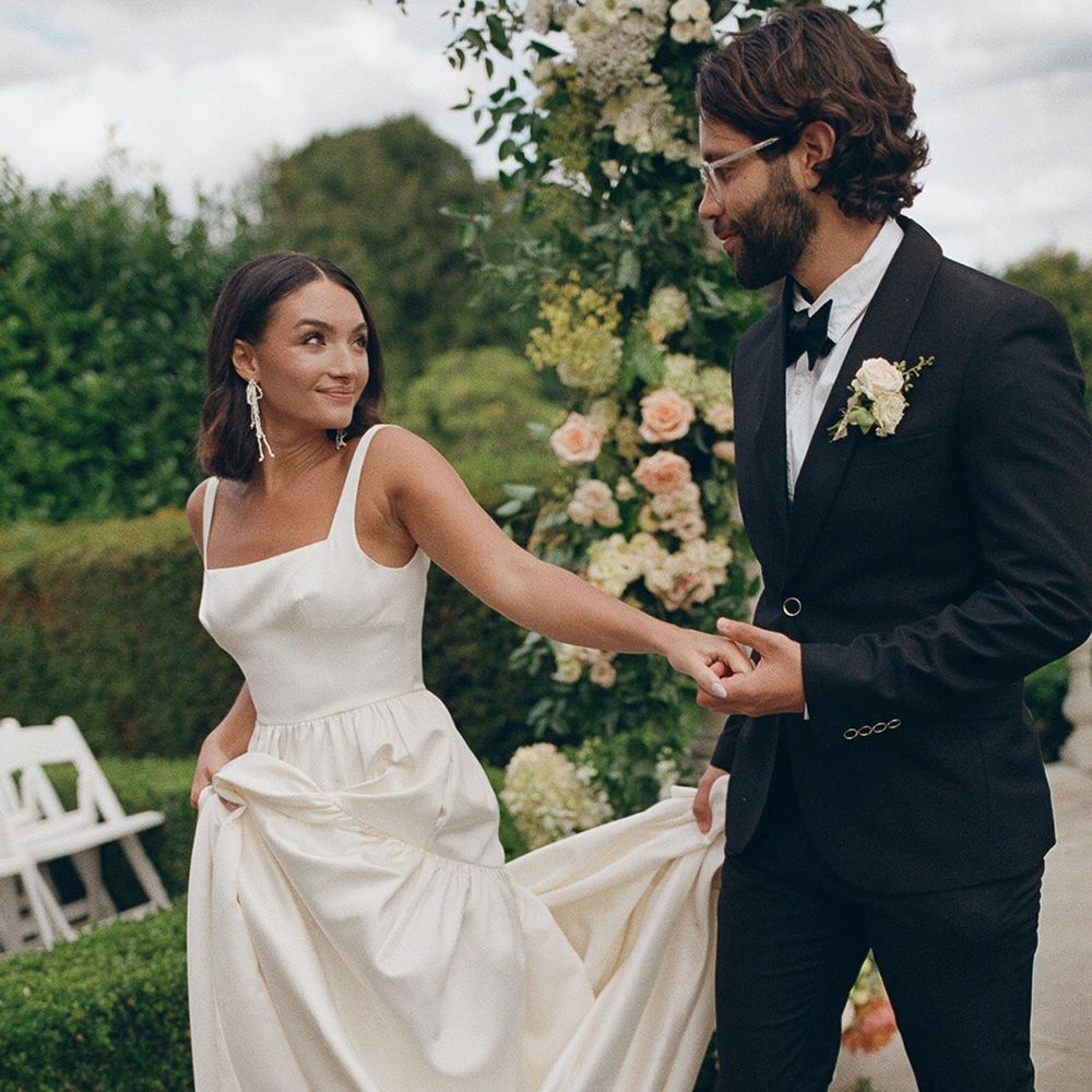 bride-in-square-neck-wedding-dress-with-groom-in-black-tuxedo
