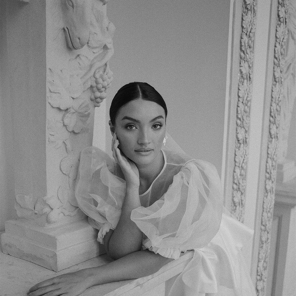 bride-wearing-wedding-dress-with-sheer-puff-sleeves-for-luxe-traditional-wedding