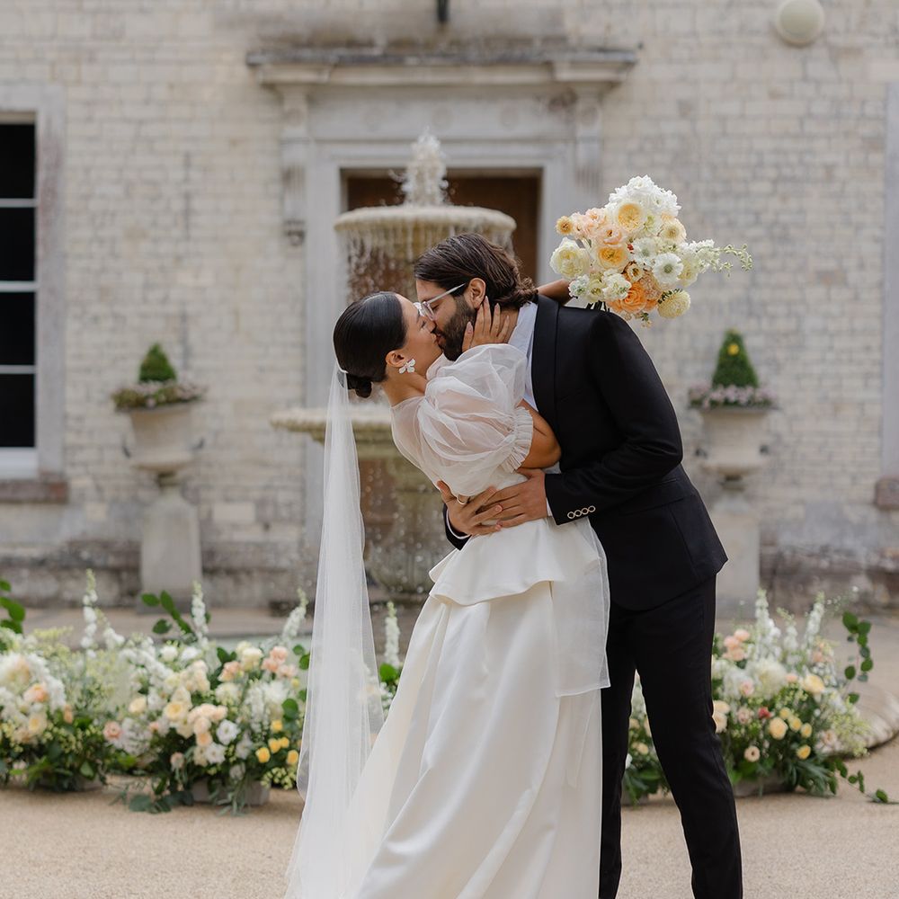 groom-in-black-tux-kissing-bride