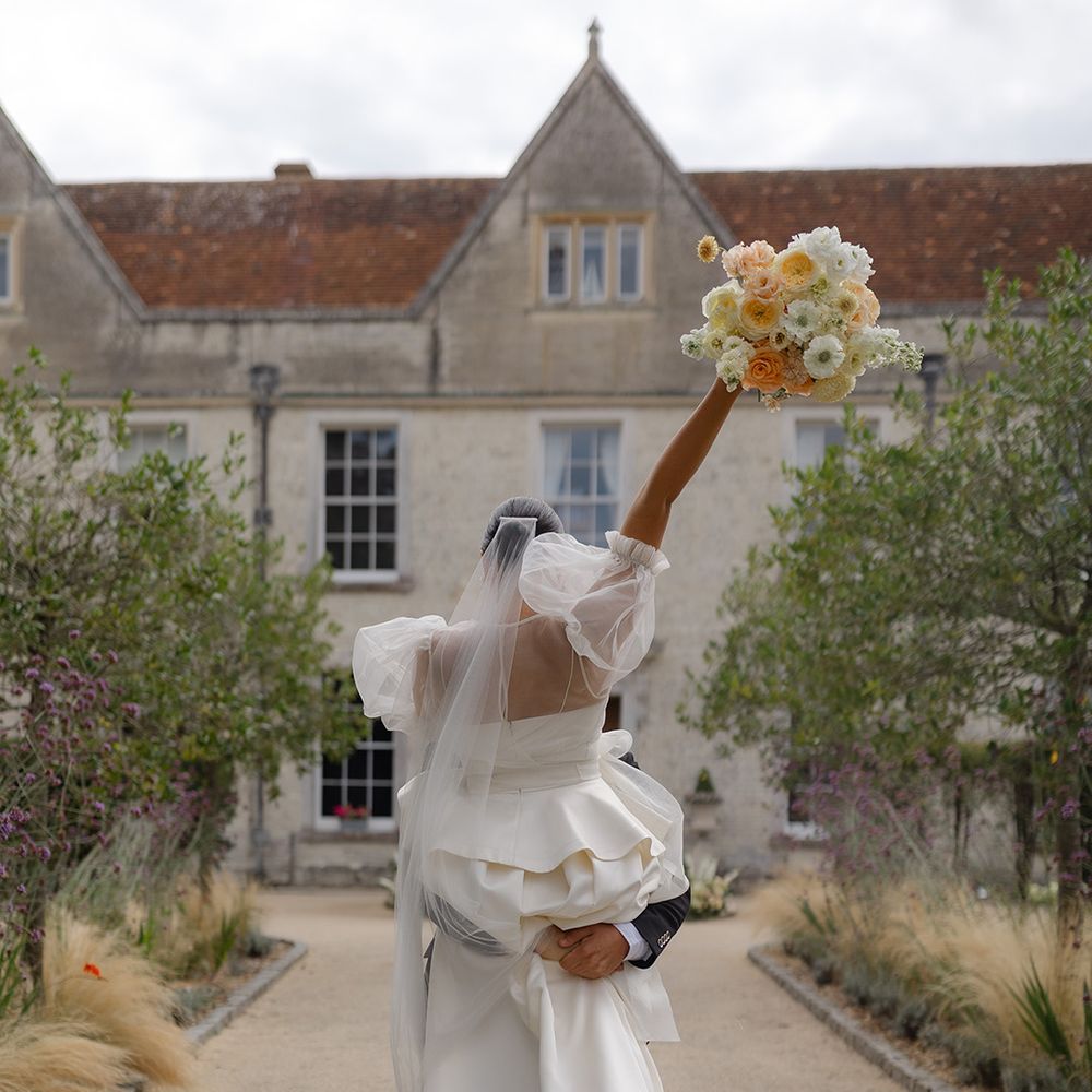 groom-lifts-bride-at-country-house-editorial-shoot
