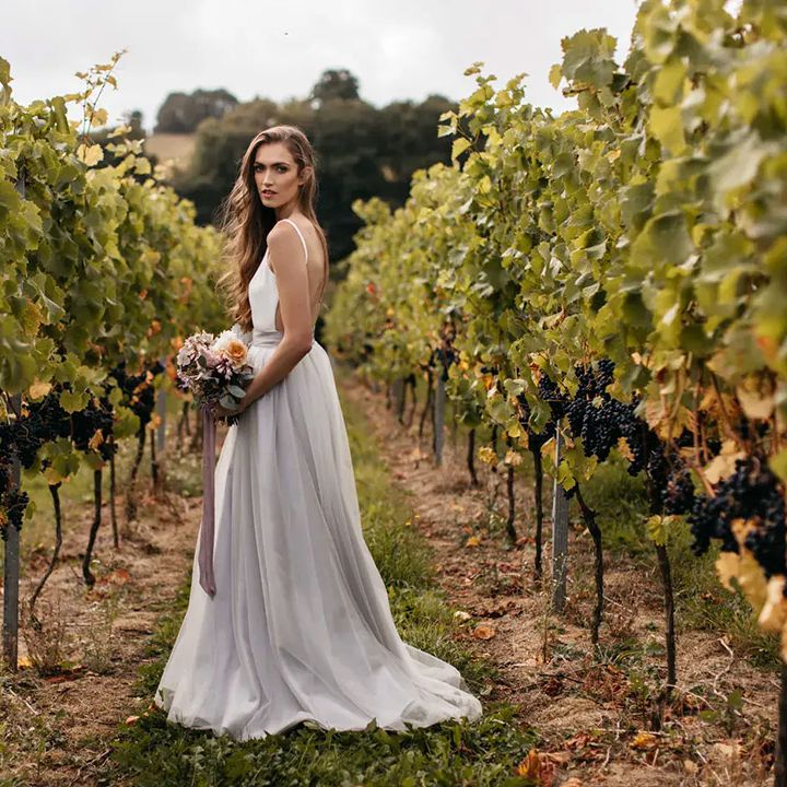 brickhouse vineyard wedding venue, bride in rows of grapevines
