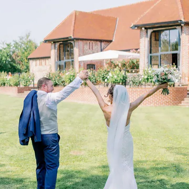tuffon hall vineyard wedding venue, couple on main lawn on their wedding day
