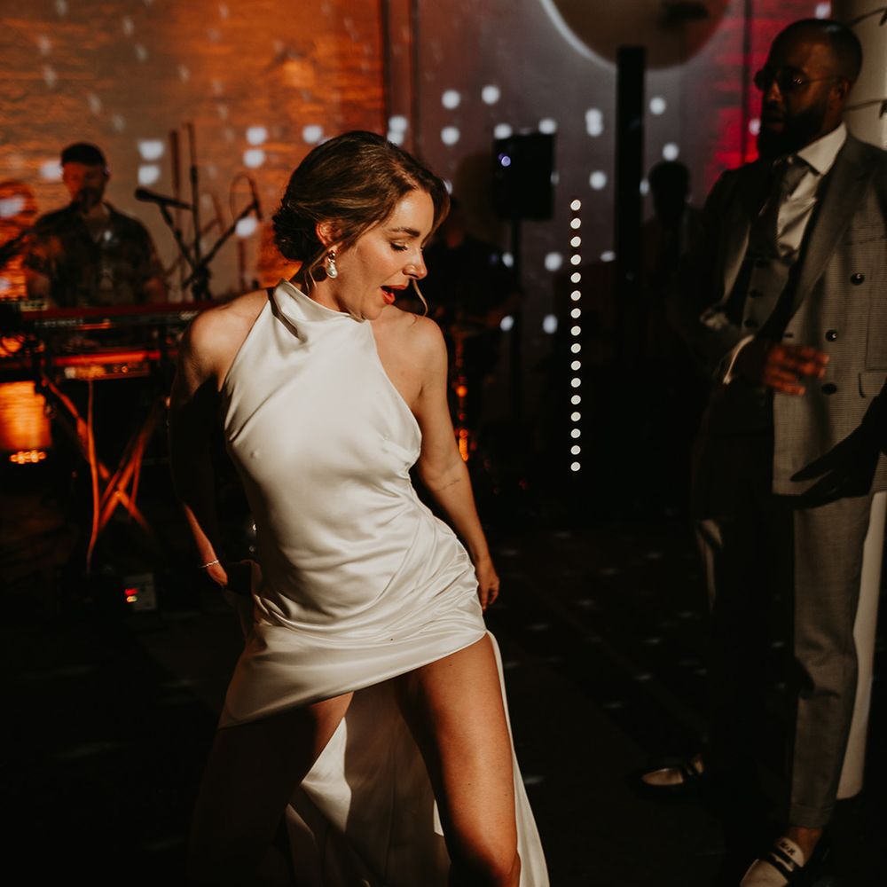 bride-in-sexy-satin-wedding-dress-dancing-at-wedding-reception