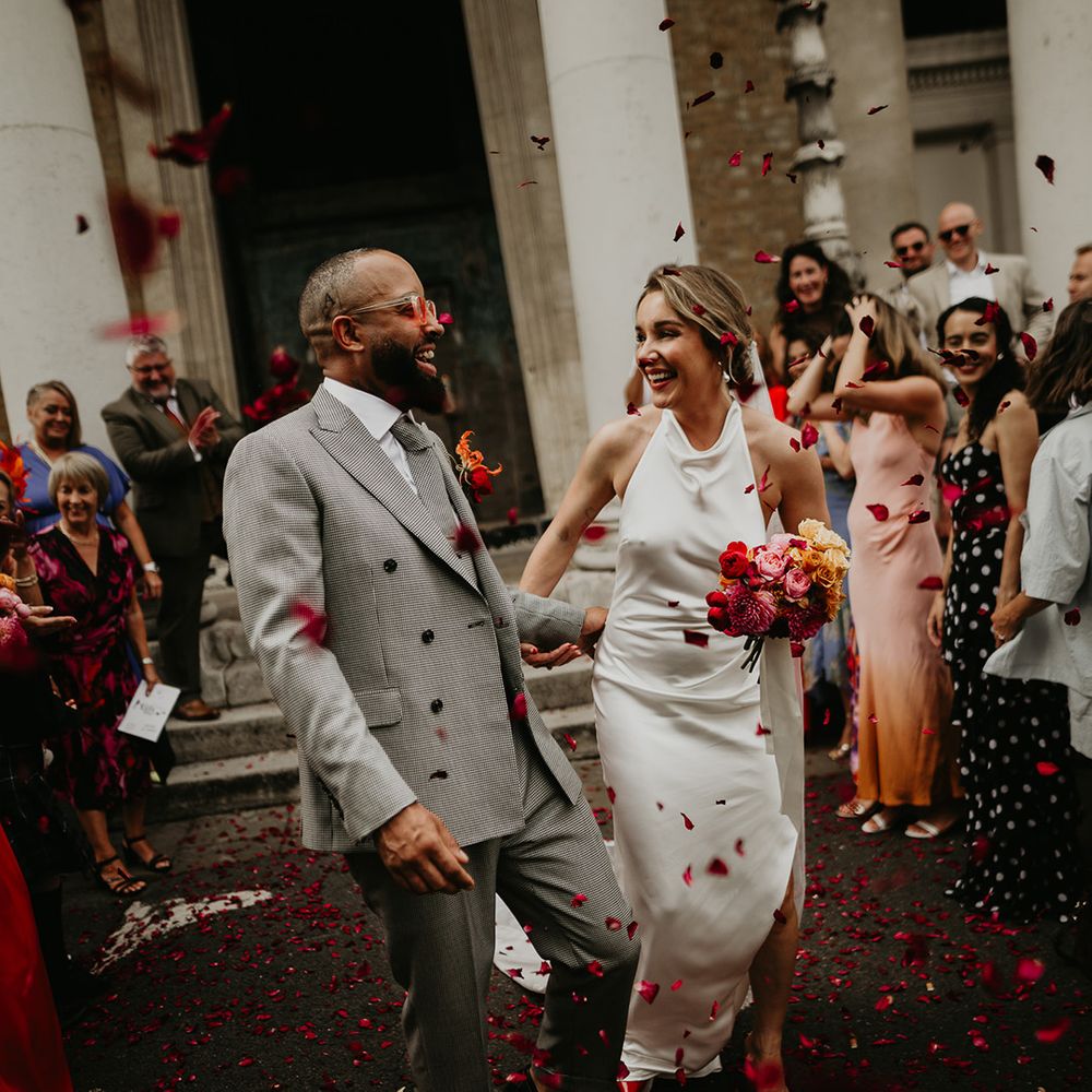 confetti-moment-at-south-london-wedding-with-bride-in-satin-wedding-dress-with-confetti