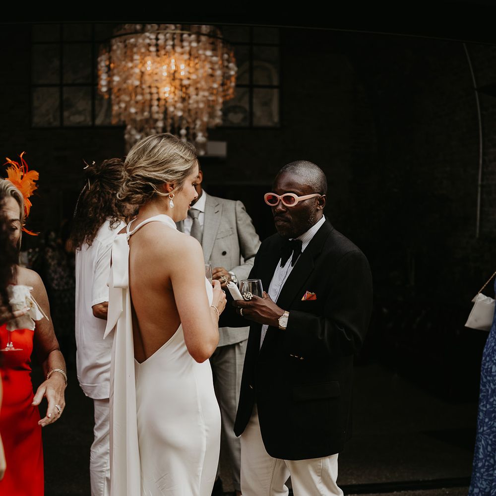wedding-guests-with-bride-wearing-halter-neck-wedding-dress