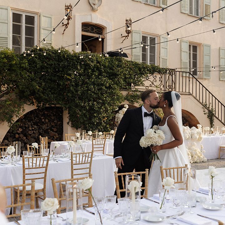 bride-and-groom-kiss-at-outdoor-wedding-breakfast