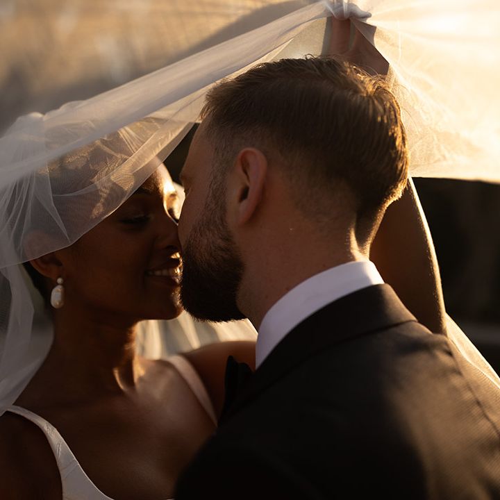 bride-and-groom-kiss-under-veil