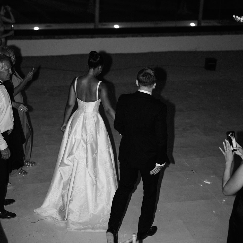 bride-and-groom-walk-hand-in-hand-at-wedding