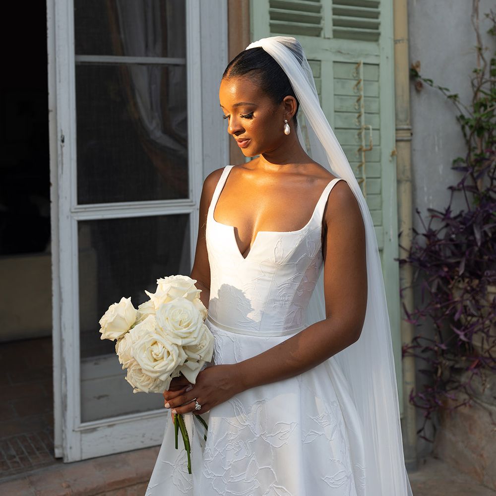 bride-in-suzanne-neville-wedding-dress-with-veil-and-rose-bouquet