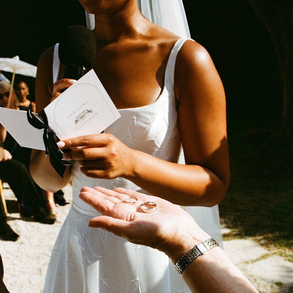 celebrant-holds-out-wedding-rings-for-the-ceremony