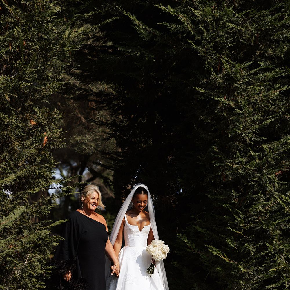 mother-of-the-bride-in-black-dress-walking-bride-down-the-aisle