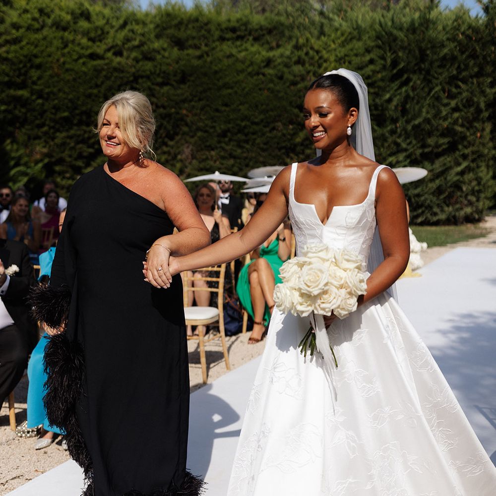 mother-of-the-bride-in-black-feather-one-shoulder-dress-walking-bride-down-the-aisle