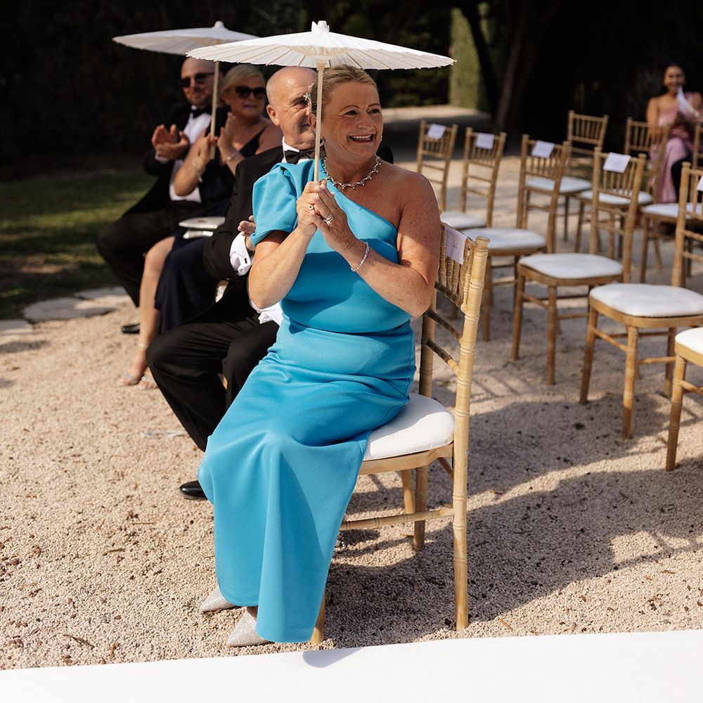 wedding-guest-in-one-shoulder-blue-dress-with-umbrella