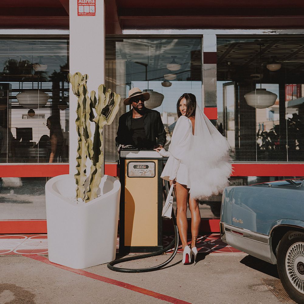 bride-in-stylish-short-wedding-dress-with-groom-by-wedding-car