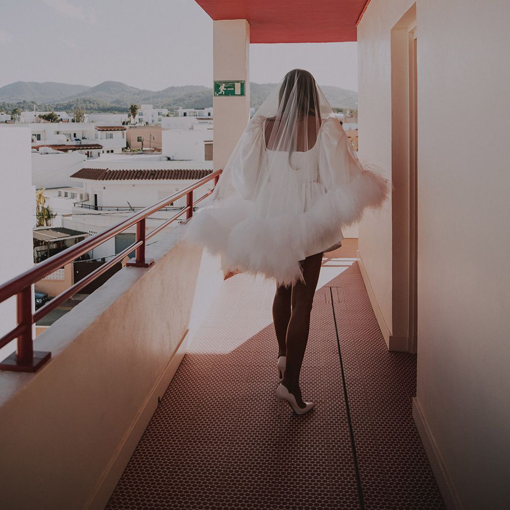 bride-wearing-ruffle-wedding-veil-with-white-louboutin-shoes