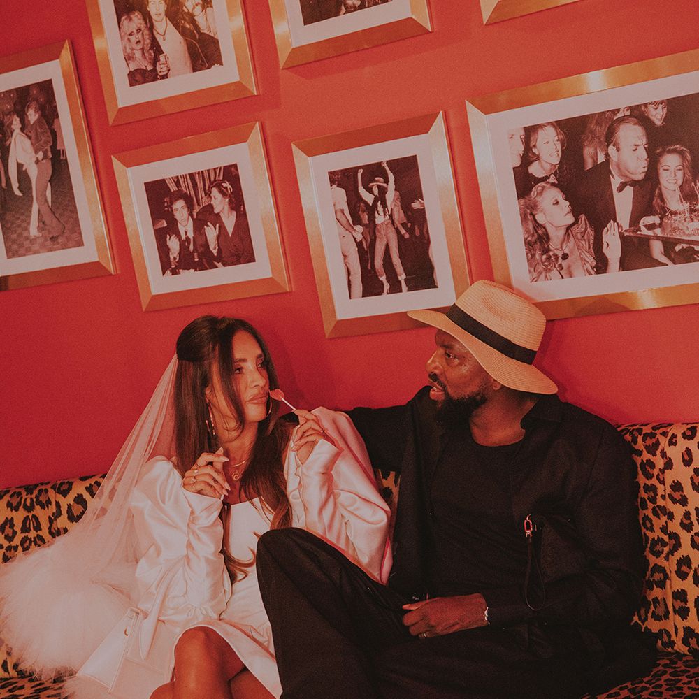 groom-with-wedding-hat-with-bride-in-short-wedding-dress