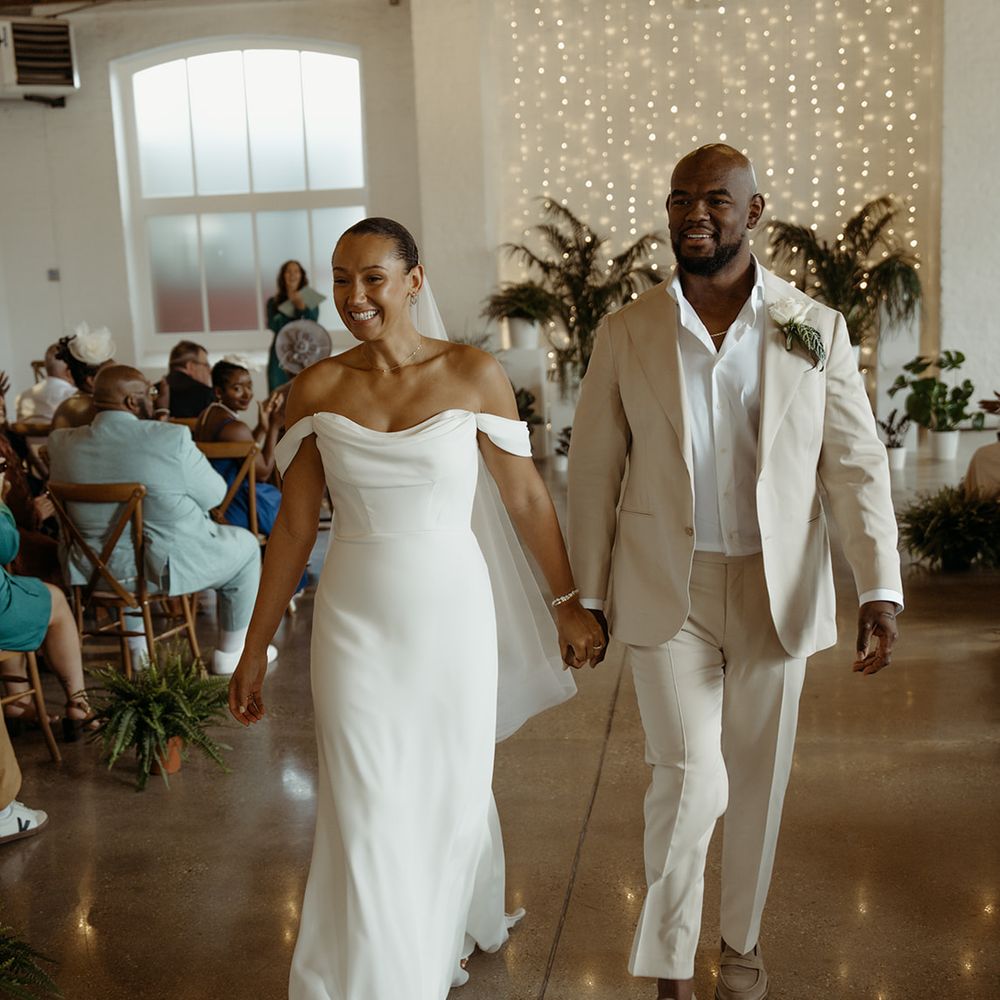 bride-and-groom-walk-back-down-the-aisle-as-a-married-couple