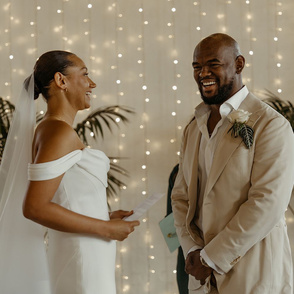bride-in-off-the-shoulder-martina-liana-wedding-dress-with-groom-in-cream-suit-jacket