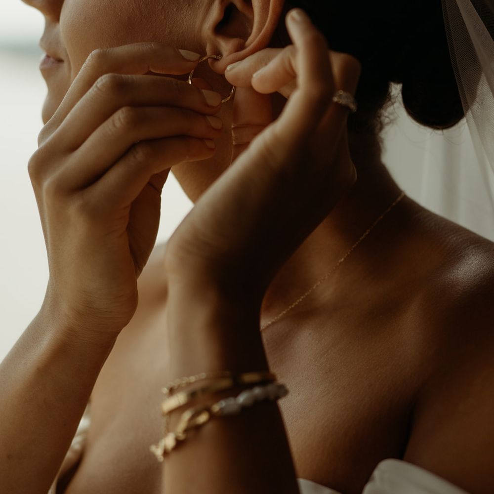 bride-puts-in-earrings-for-wedding-day-jewellery