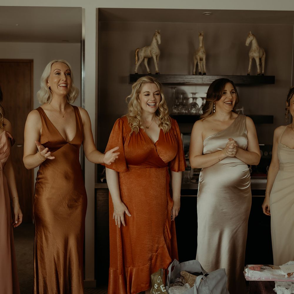 bridesmaids-in-mismatched-autumnal-bridesmaid-dresses-see-the-bride-for-the-first-time