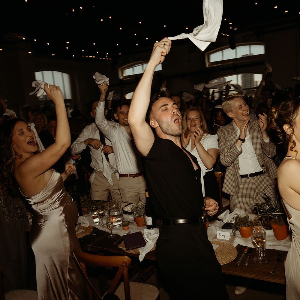 wedding-guests-wave-napkins-to-welcome-the-happy-couple