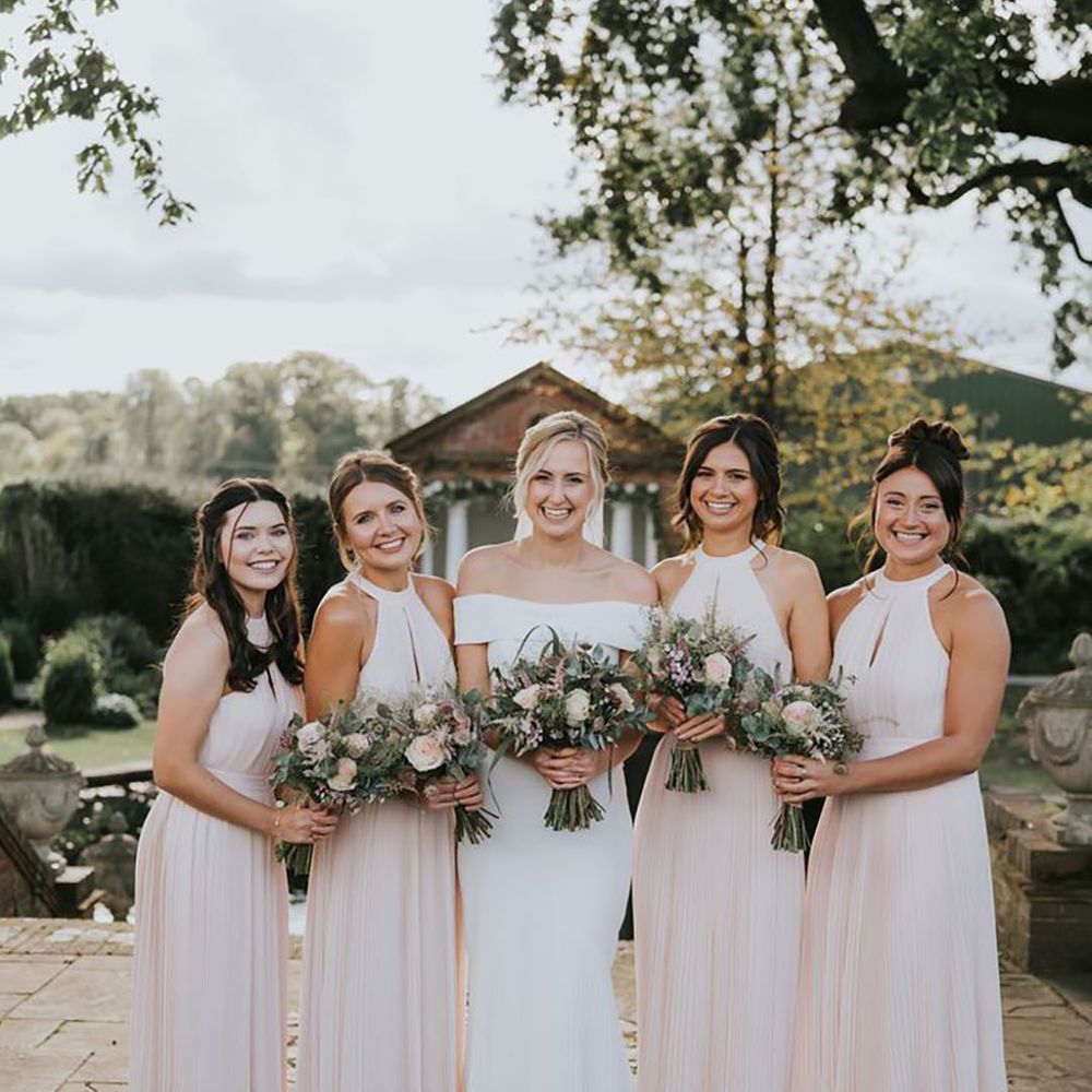 bride with bridesmaids wearing blush pink bridesmaid dresses