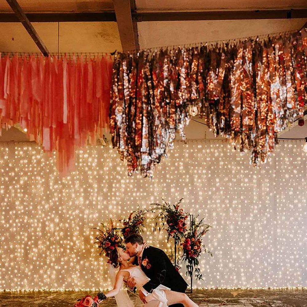 bride and groom with disco themed metallic wedding and streamers