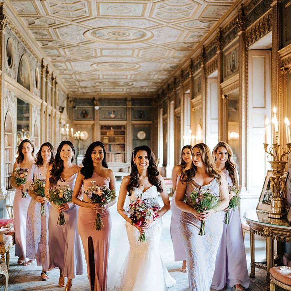 bride with her bridesmaids wearing lavender bridesmaid dresses