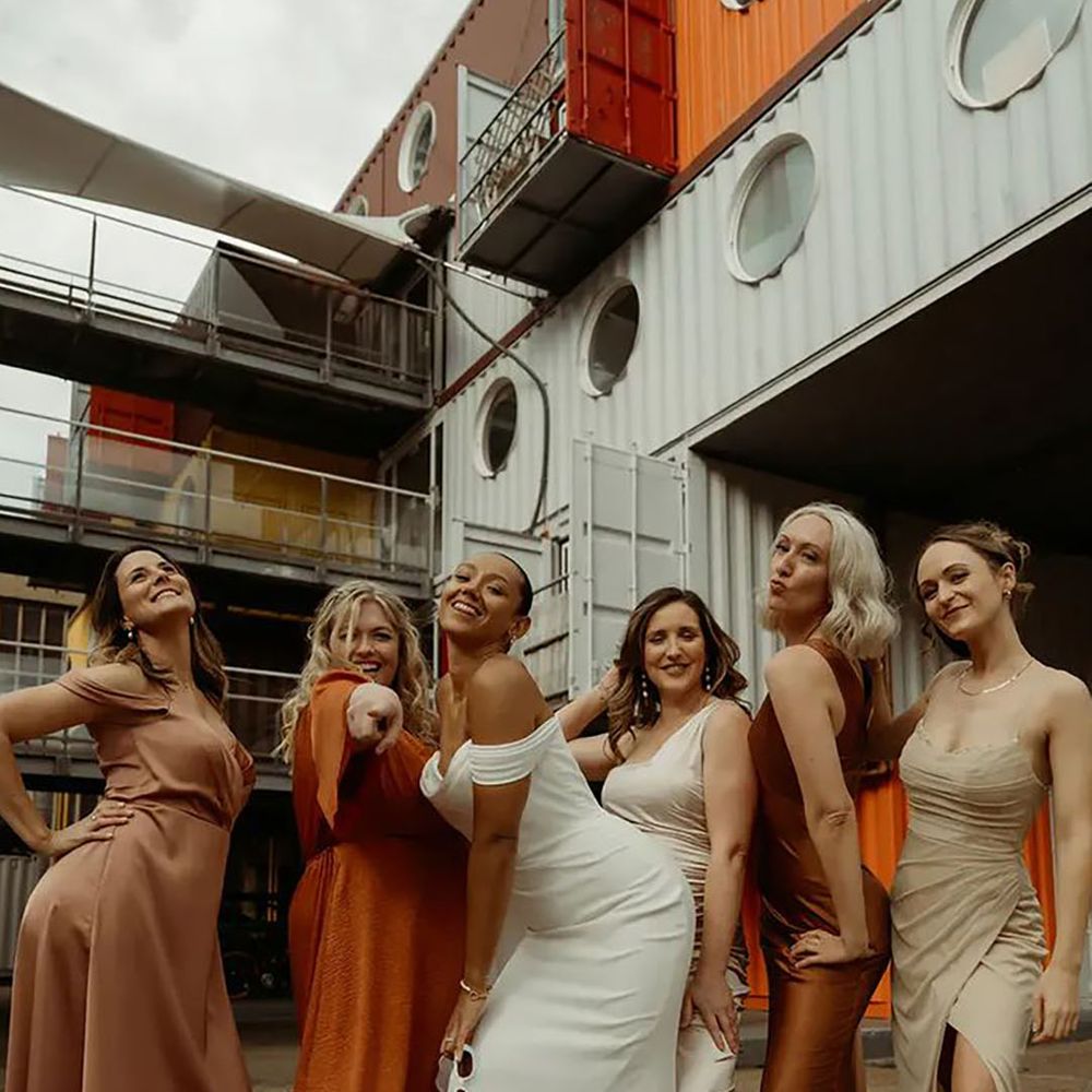 mismatched orange and neutral toned bridesmaid dresses