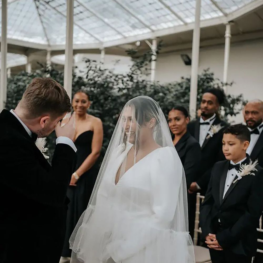 bride and groom at altar with guests in black tie dress code