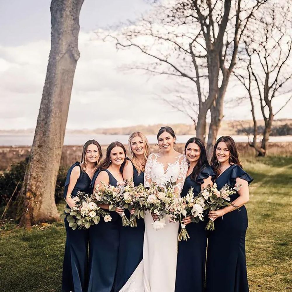 bride with bridesmaids wearing navy blue bridesmaid dresses
