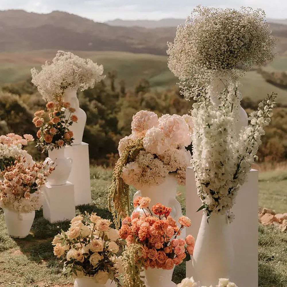 neutral wedding flowers in sculpted statement pots
