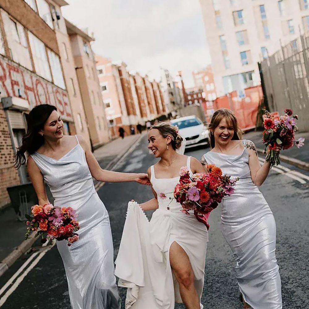 bride with bridesmaids wearing silver metallic dresses