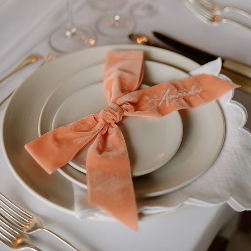 peach table decor for wedding, including velvet peach bow