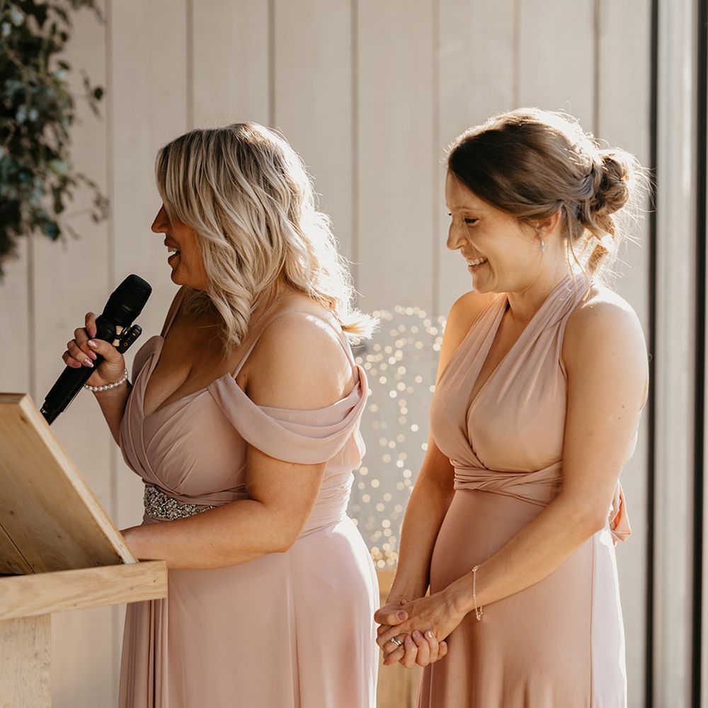 bridal-party-wearing-pink-bridesmaid-dresses-read-wedding-speech