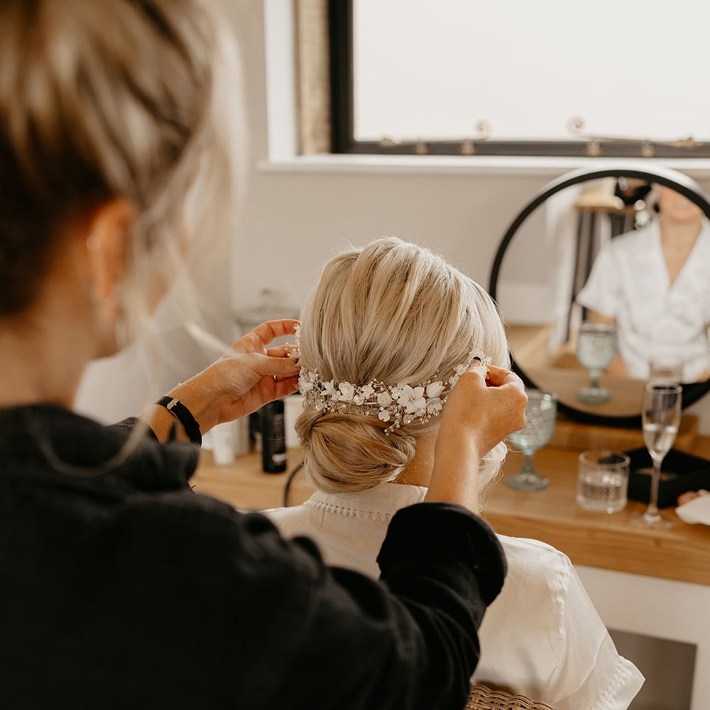 bride-blonde-hair-updo-with-flower-hair-accessory