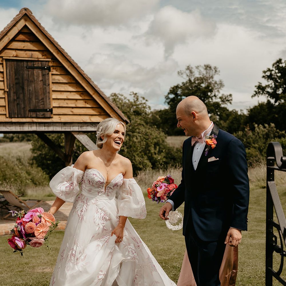 bride-wearing-pink-flower-colourful-wedding-dress-with-groom-at-primrose-hill-farm