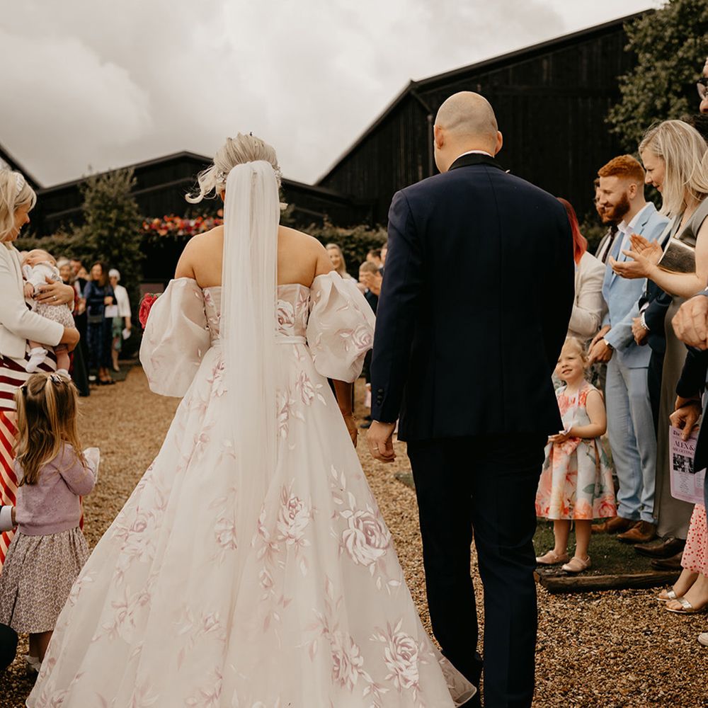 bride-wearing-pink-flower-wedding-dress-with-puff-sleeves