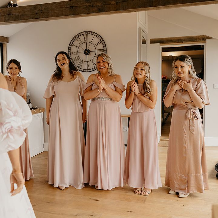 bridesmaids-in-pink-bridesmaid-dresses-get-first-look-at-bride
