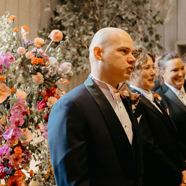 groom-stands-with-wedding-party-at-wedding-altar