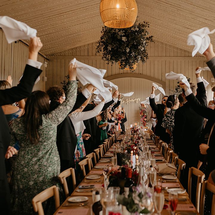 guests-wave-wedding-napkins-in-greeting