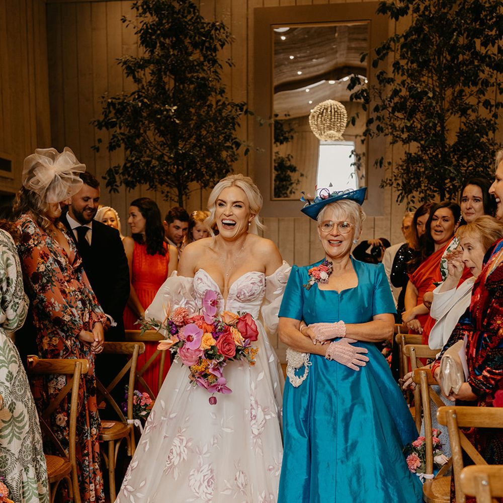mother-of-the-bride-in-blue-dress-walks-bride-down-the-aisle