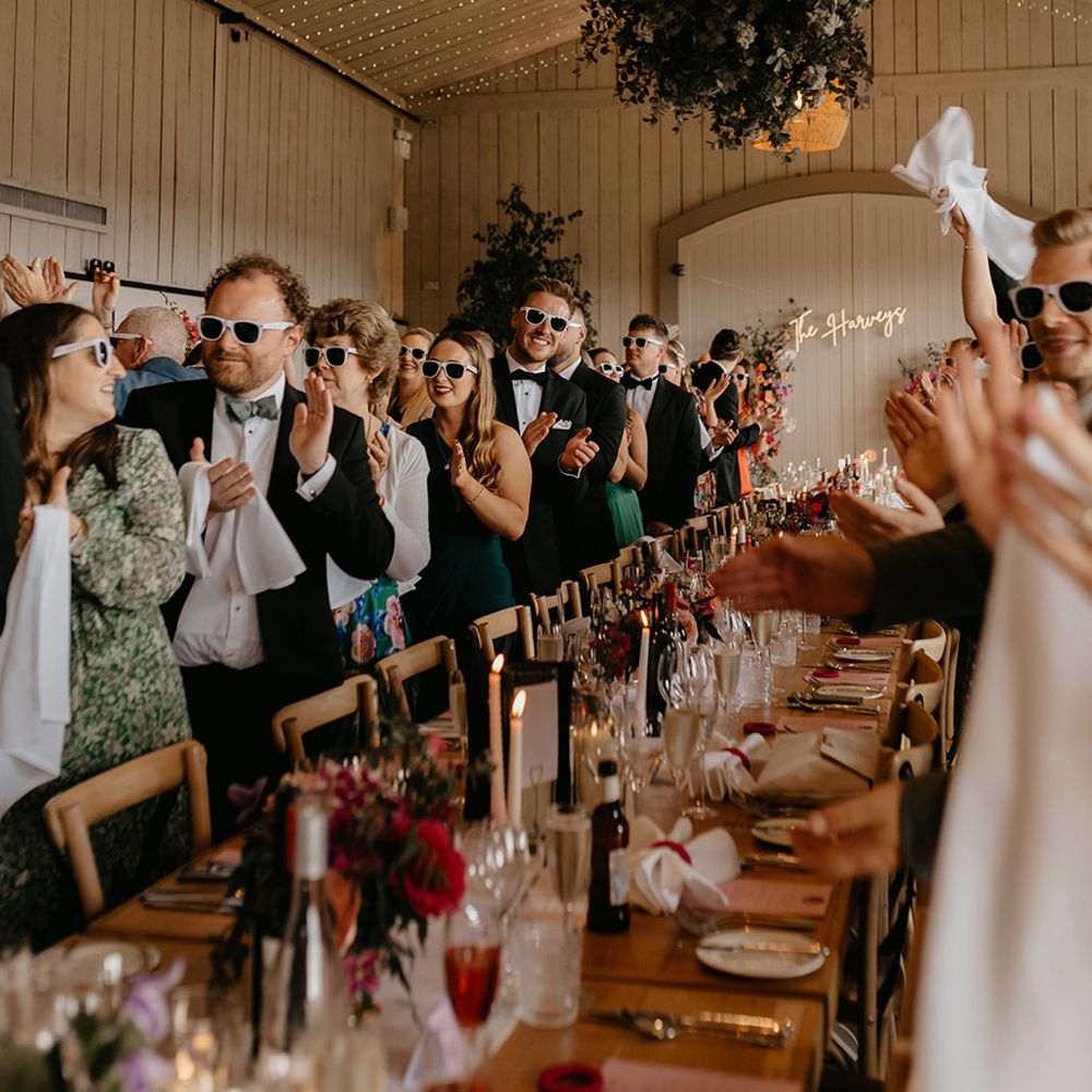 wedding-guests-stand-for-bride-and-groom