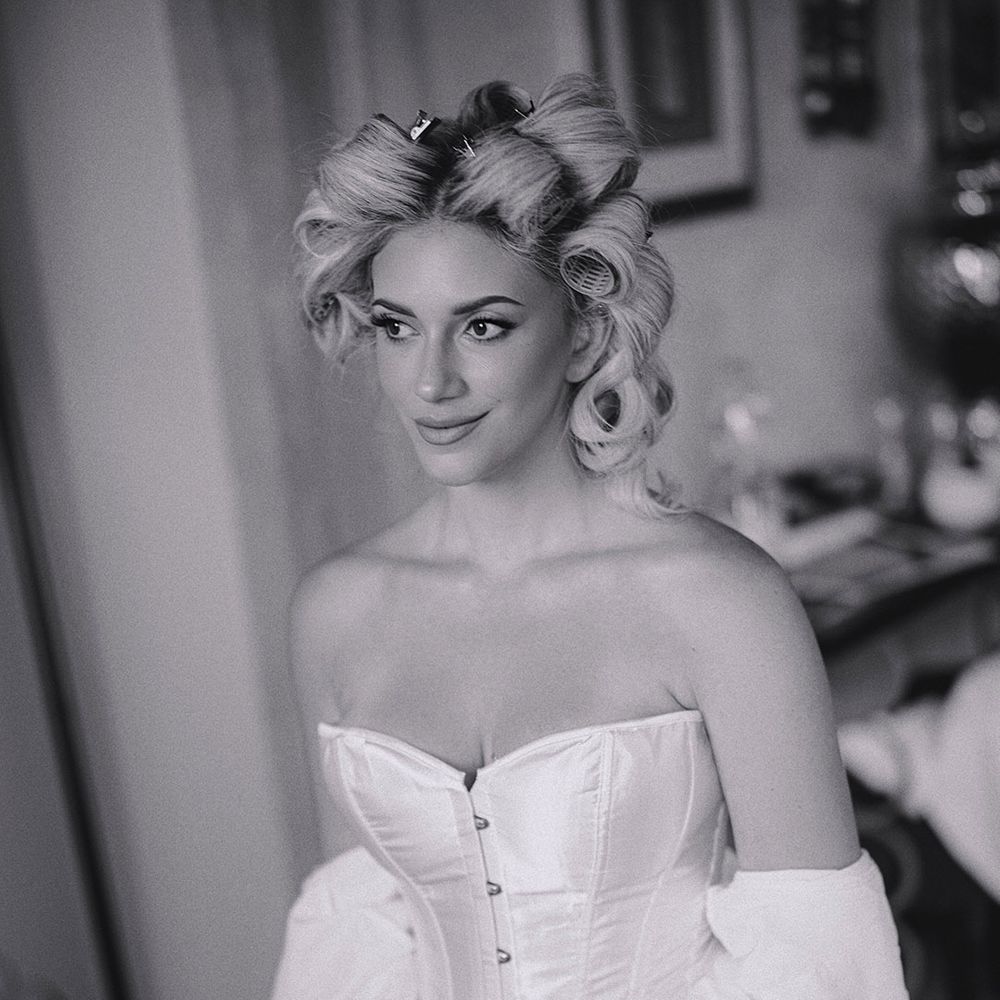 bride-in-corset-getting-ready-for-wedding-with-hair-rollers
